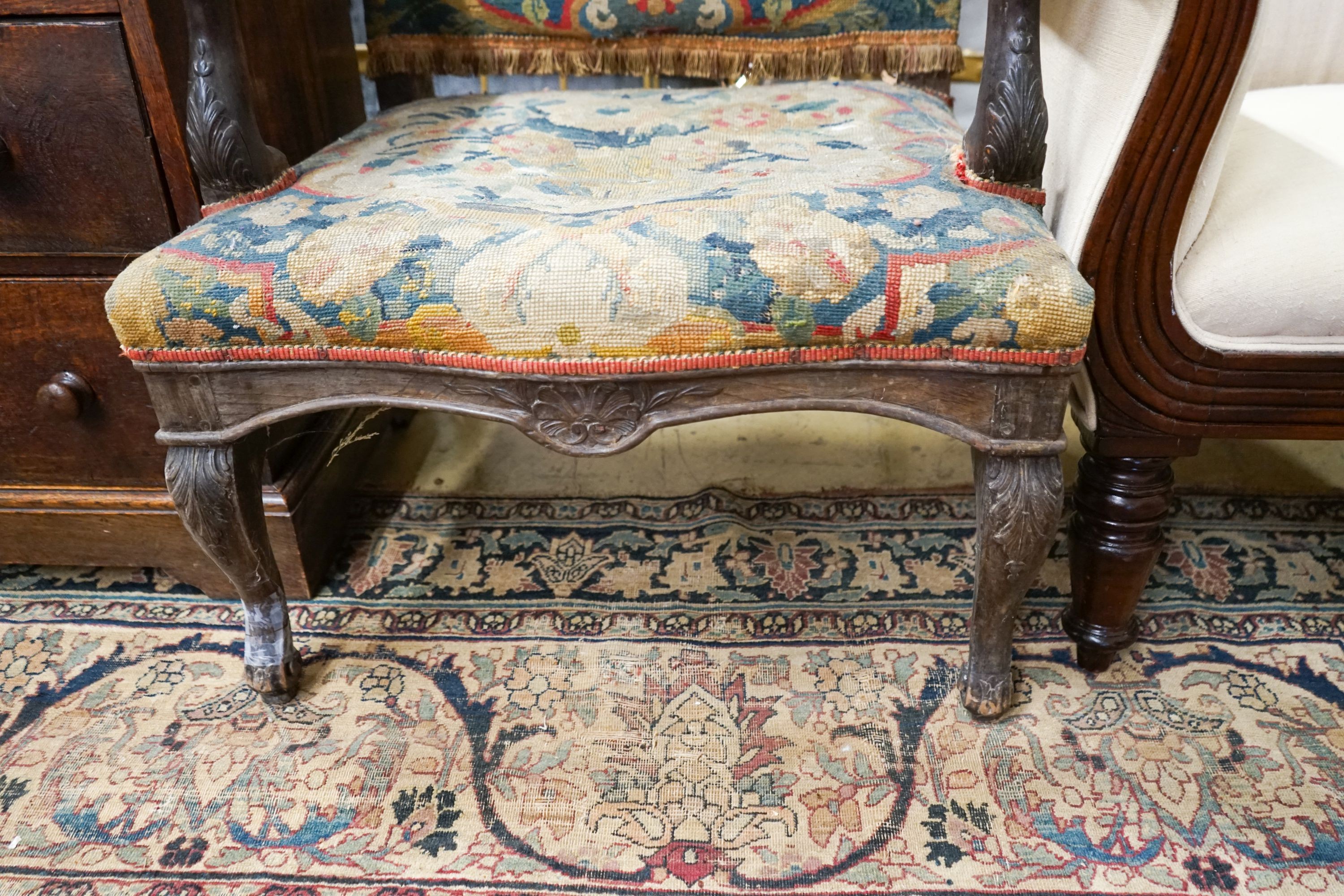 An 18th century French carved walnut elbow chair with tapestry upholstery, width 60cm, depth 58cm, height 104cm